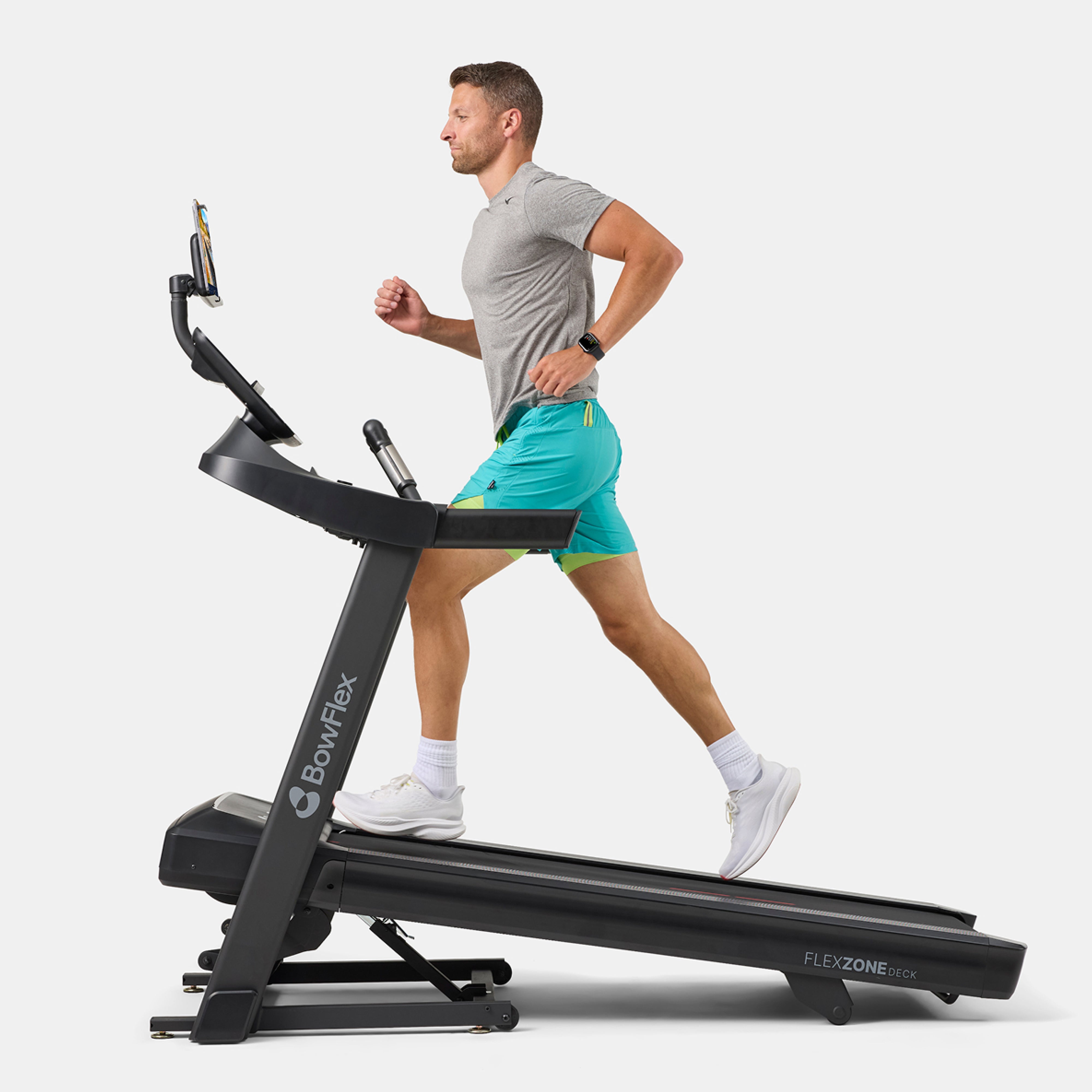 Man running on a BowFlex T6 treadmill, shown from the side on a white background.